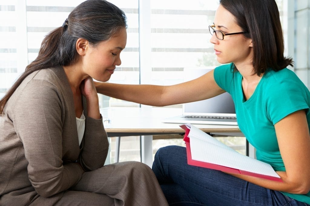 Woman Having Counselling Session Sitting Down Upset